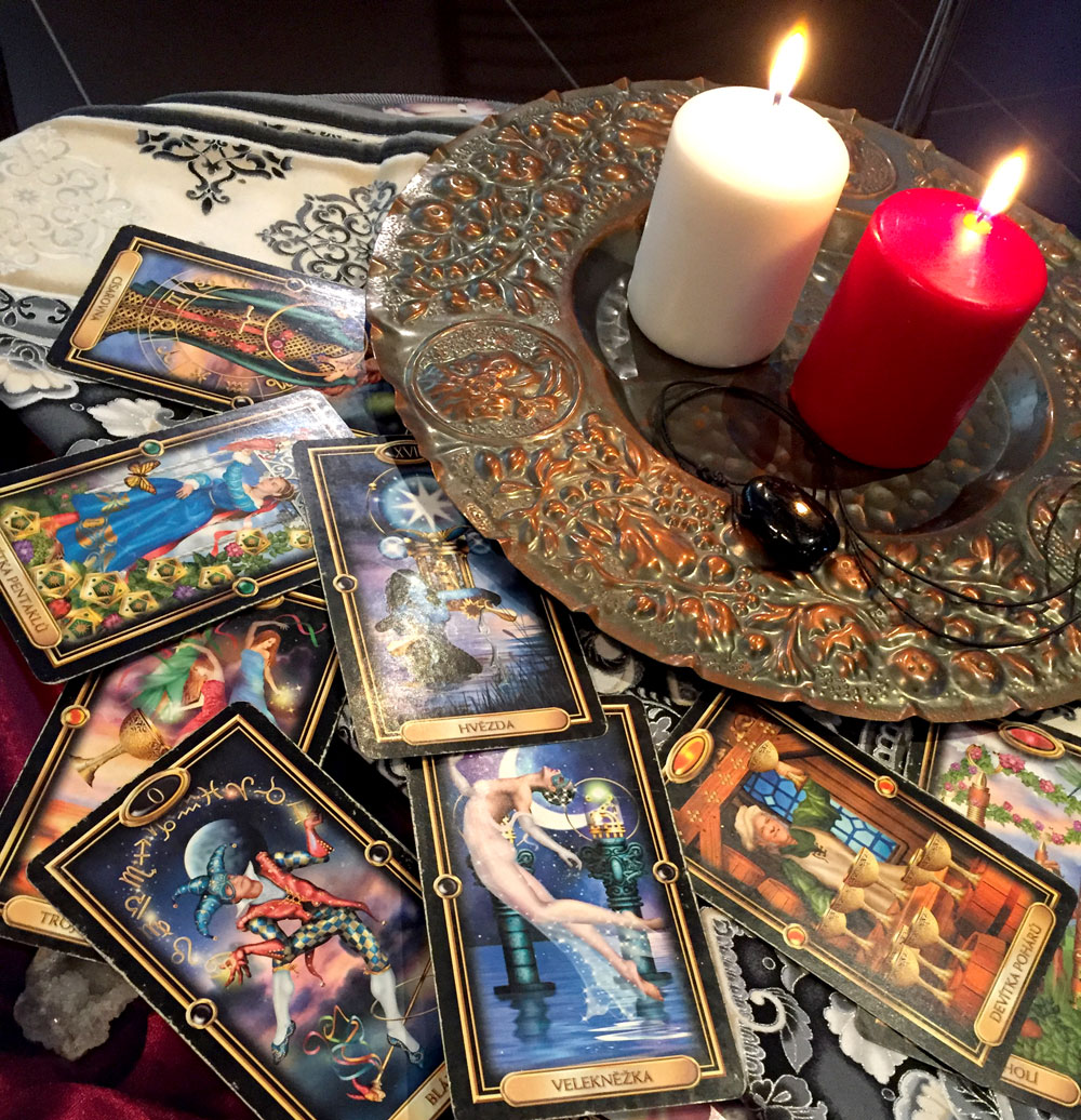 Photo of tarot cards and a lit candle